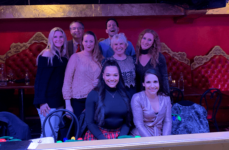 The team at Northwest Dental Medicine wearing nice clothes while posing in a restaurant.